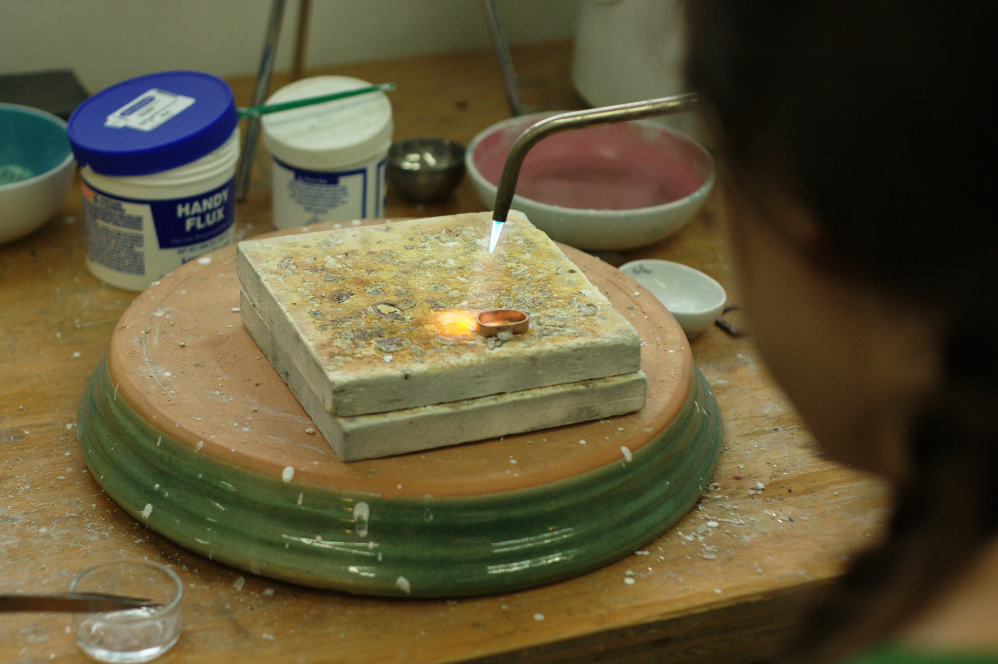 Rebecca heating Tom’s ring before soldering